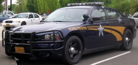 A former fleet manager for the Oregon State Police resigned on Friday, following the filing of crimi