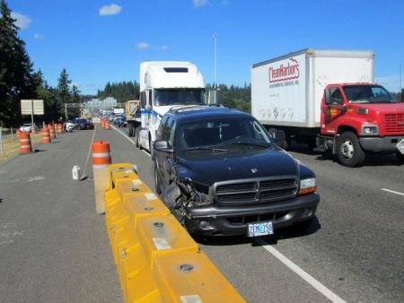 Three vehicles were damaged, and fortunately no one was injured, after the left rear dual axle of a semi-trailer came loose along Interstate 5 near Lower Boones Ferry Road near Tigard. Photo Courtesy: Oregon State Police