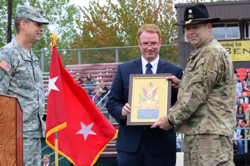 State Sen. Tim Knopp (R-Bend), representing Oregon Governor Kate Brown, returns a framed guidon flag representing 1st Squadron, 82nd Cavalry Regiment, to the squadron commander, Oregon Army National Guard Lt. Col. Daniel D. Miner, Jr.