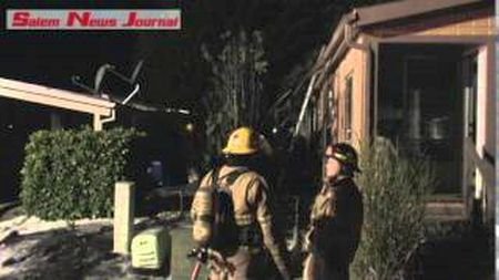 A fire in a row of arborvitae trees in a Keizer manufactured home park Saturday night could have been a lot worse, if firefighters had not been called in time. Photo: Jerry Freeman Salem News Journal
