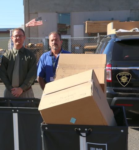 From the left: Stan Sorensen and Kyle Dickenson UGM employees receiving boxes. Photo Courtesy: MCSO