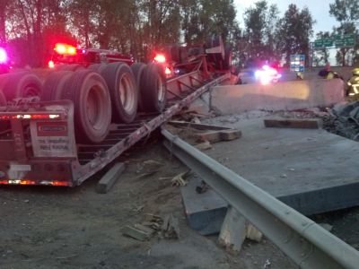 When firefighters arrived they found an overturned semi tractor and trailer on the ramp. The truck w