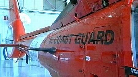 A Coast Guard MH-65 Dolphin helicopter crew rescues two stranded hikers near Cape Arago, Ore. Photo 